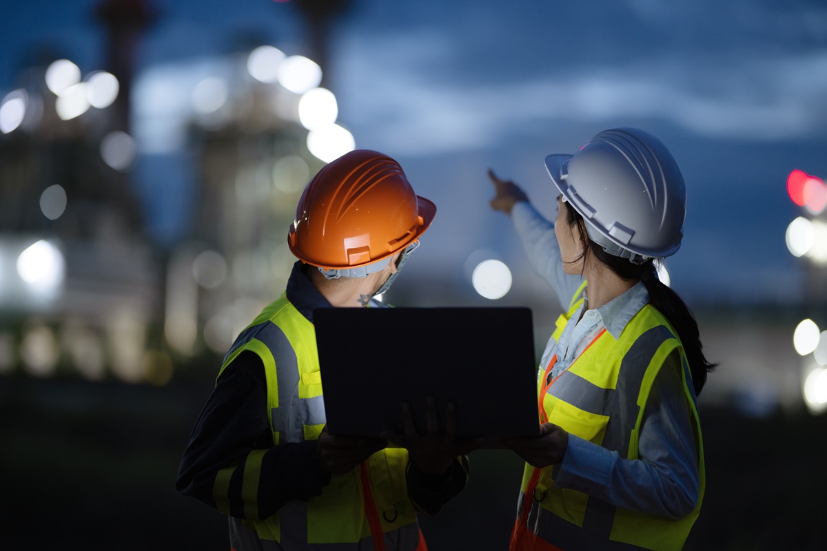 Operations and Maintenance Service In Field Support for Energy Generation. Rear View of Field Support Engineers working in a Power Plant to diagnose and enhanced plant performance during on-site service.