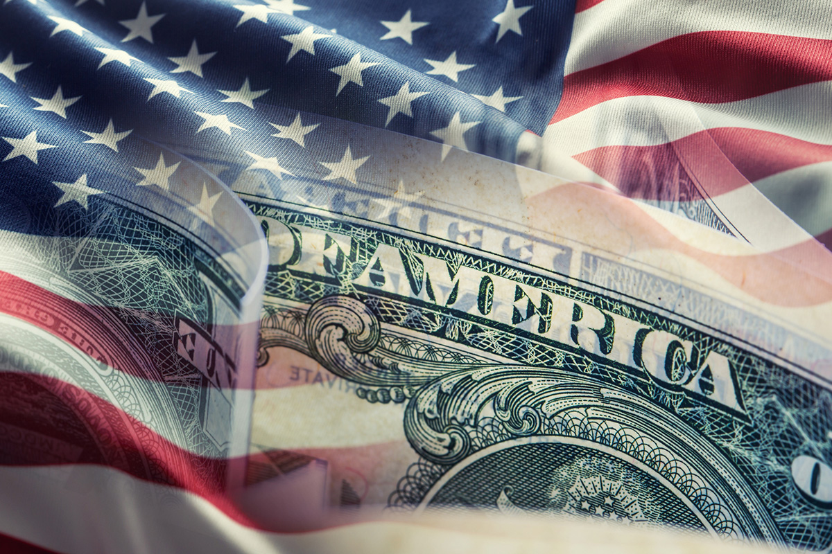 American flag and dollar banknotes - business background.