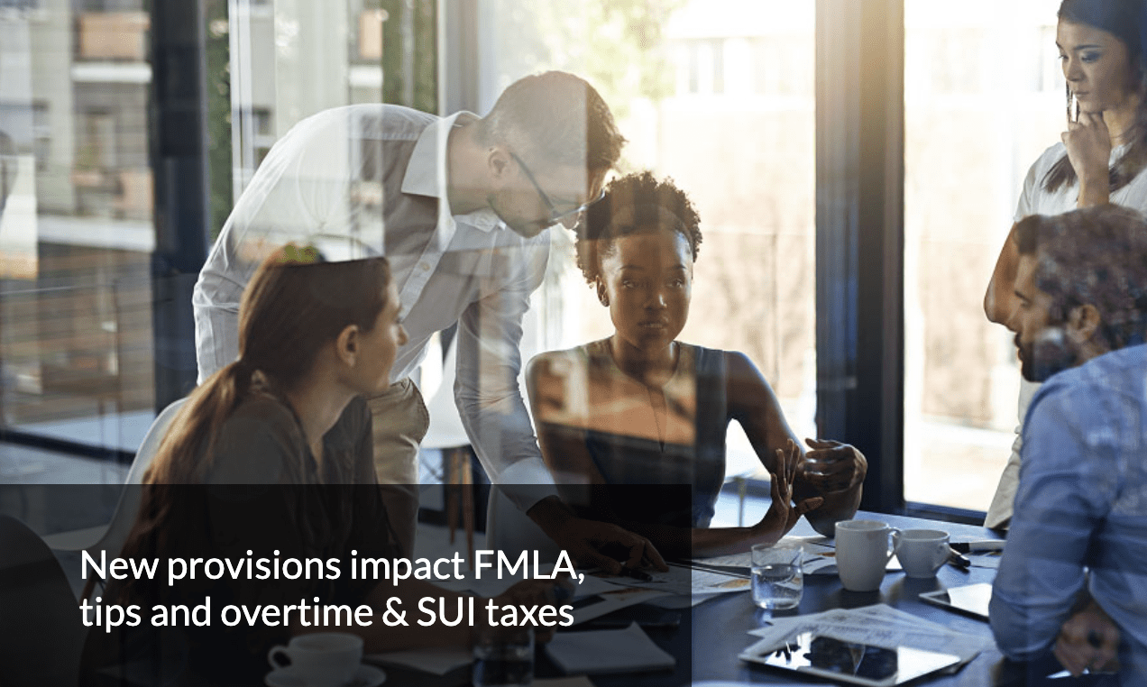 Shot through a glass wall, employees sit or stand around a conference room table. White text in the bottom left reads 