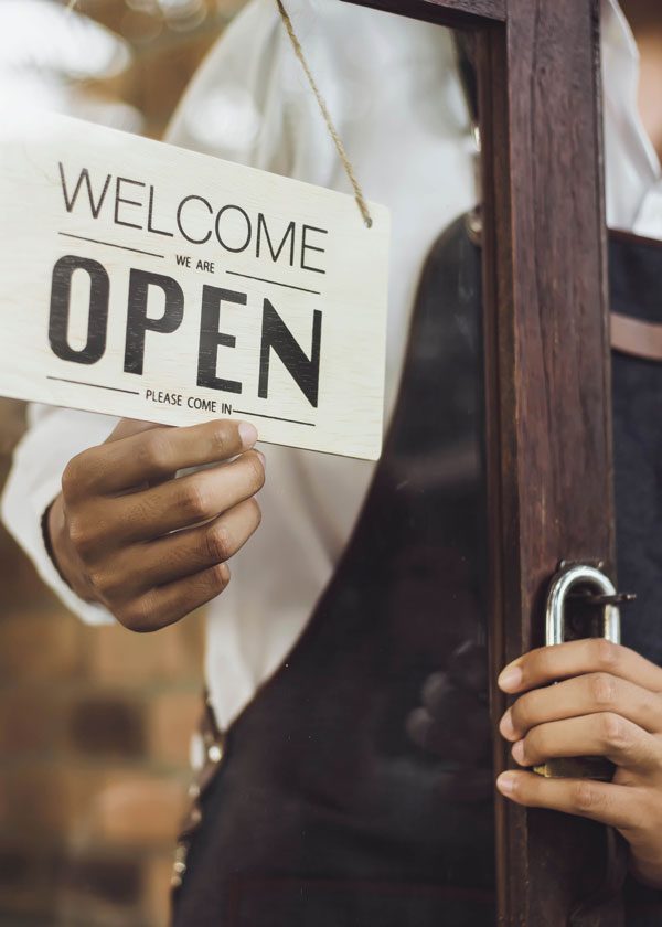 Close up of a hand turning a paper sign that reads 