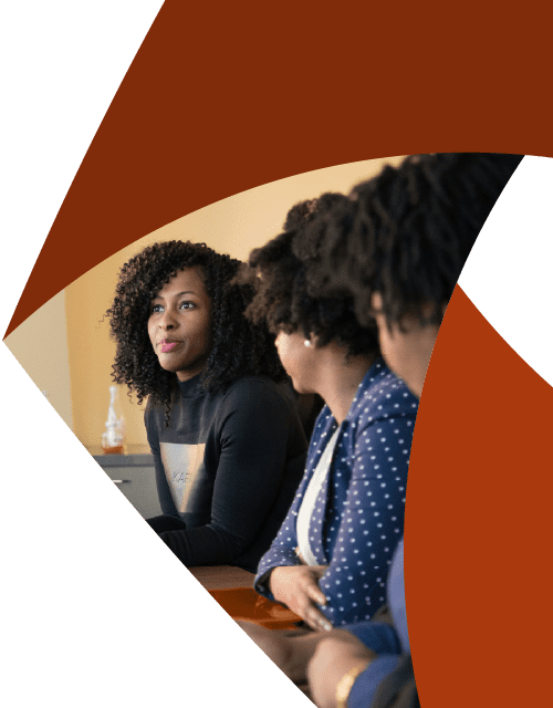 In the corner of the Aprio pinwheel logo, two women watch a third woman who looks at something off camera