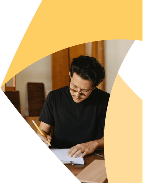 In a corner of the Aprio pinwheel logo, a man sits at a table and writes on a clipboard