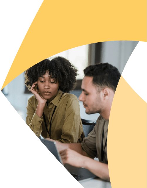 In a corner of the Aprio pinwheel logo, a man and woman sit together and look at something on the table