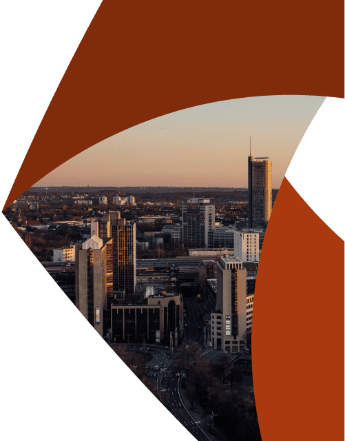 In the corner of the Aprio pinwheel logo, a city skyline appears beneath a rosy sky