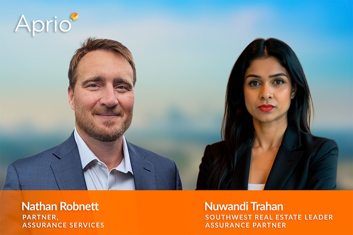 Two professionals, Nathan Robnett and Nuwandi Trahan, are shown in business attire with their names, titles, and the Aprio company logo displayed on a blurred background.