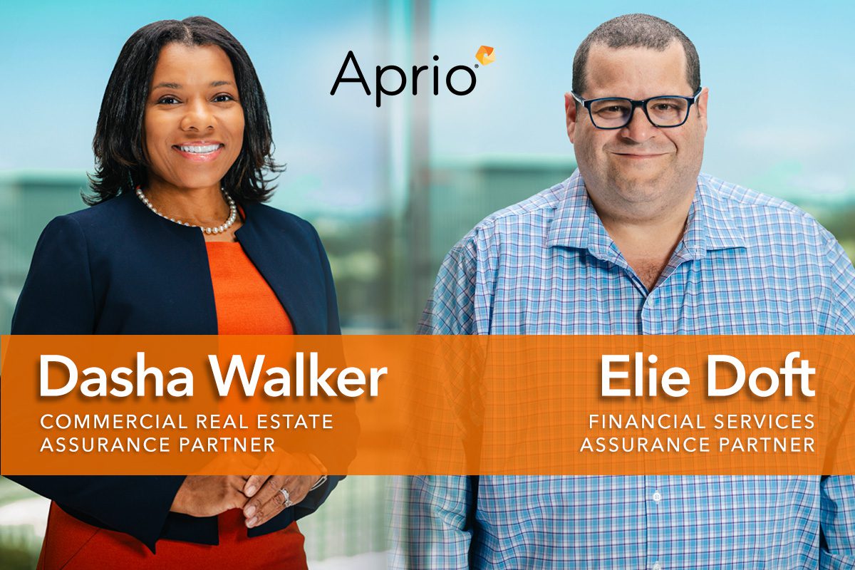 Dasha Walker and Elie Doft pose in business attire with their names and job titles displayed, alongside the Aprio company logo in the background.