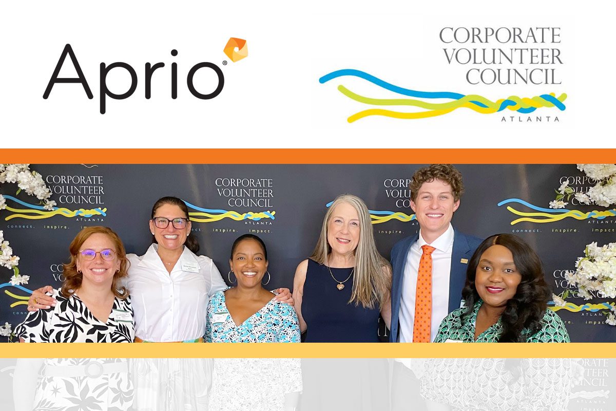 Six people pose in front of a Corporate Volunteer Council Atlanta backdrop, under the Aprio and CVC logos.