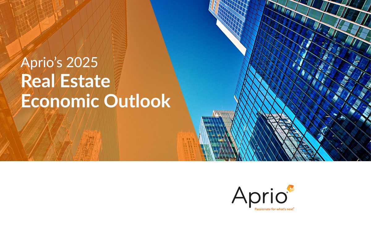 Cover slide for Aprio’s 2025 Real Estate Economic Outlook featuring modern glass office buildings against a blue sky.