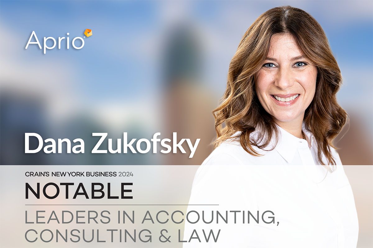 Dana Zukofsky poses smiling in a business portrait with the Aprio logo and a Notable Leaders in Accounting, Consulting & Law recognition banner.