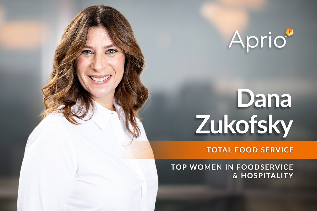 A woman with brown hair smiles at the camera. Text reads: Aprio. Dana Zukofsky. Total Food Service. Top Women in Foodservice & Hospitality.