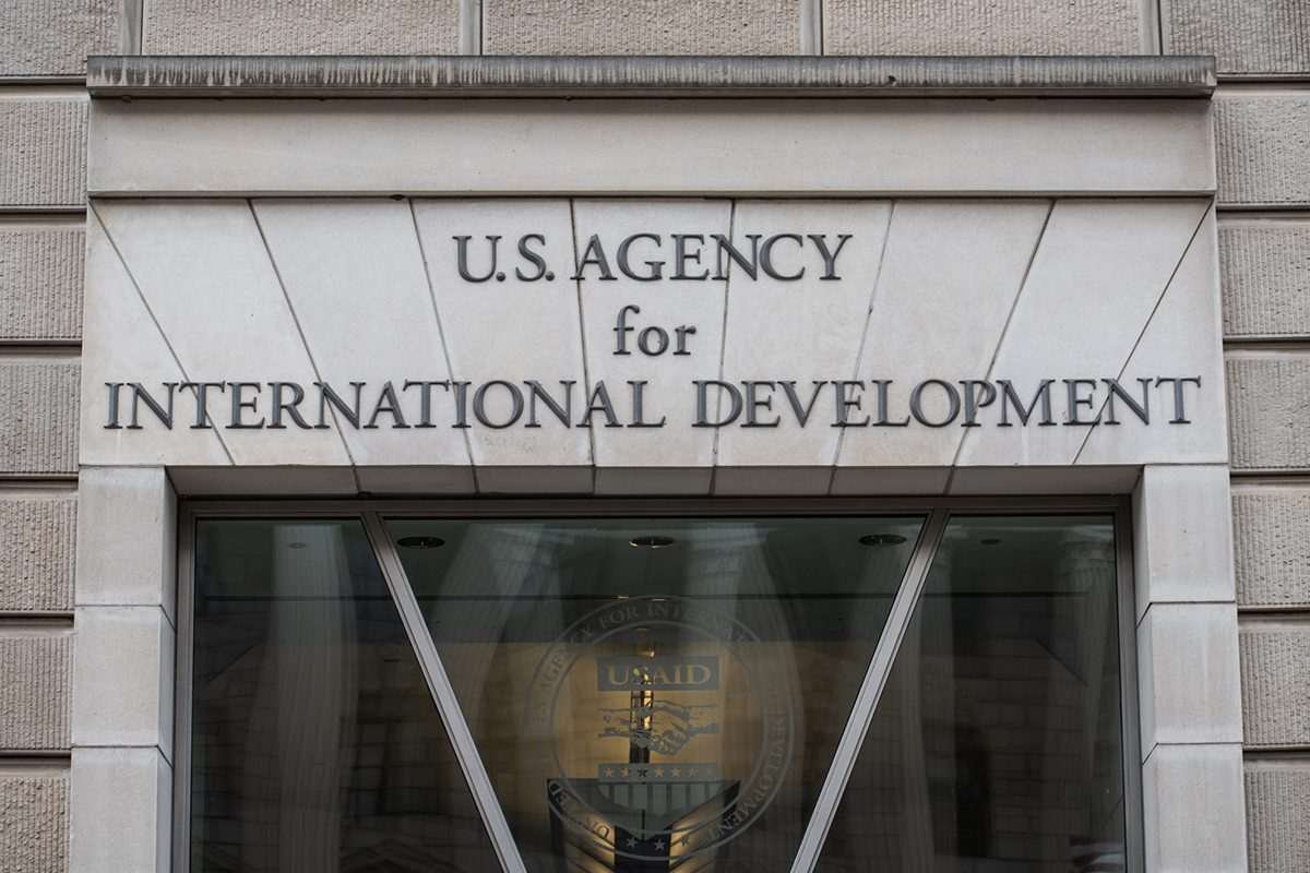 The entrance of a building with U.S. Agency for International Development engraved above a glass door.