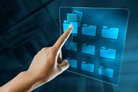 A hand is touching a virtual screen with blue digital folders, selecting one folder containing several documents.
