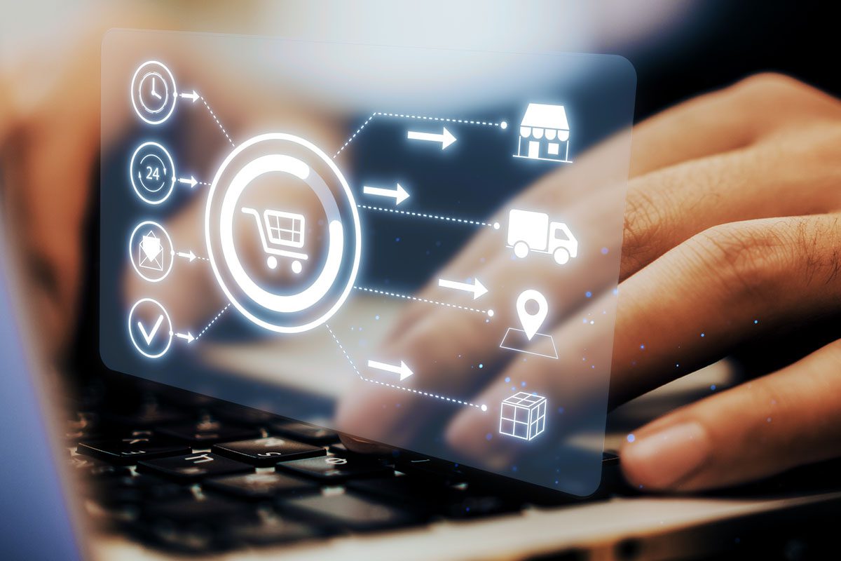A hand types on a laptop keyboard with a transparent shopping cart interface and icons representing online shopping and delivery processes.