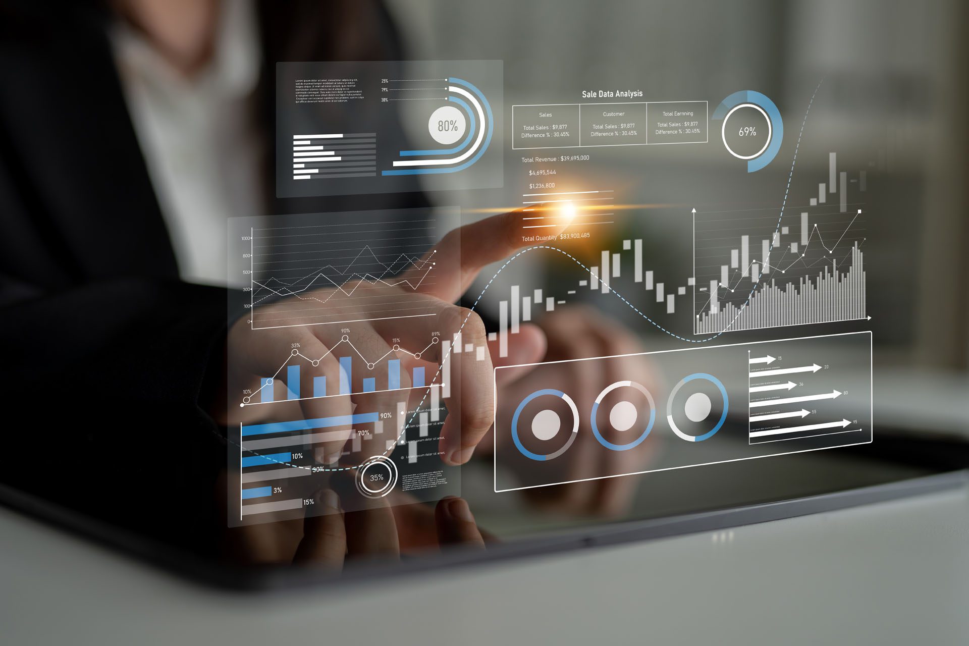 A person interacts with digital graphs and charts on a touchscreen, displaying data visualizations including bar charts, pie charts, and line graphs.