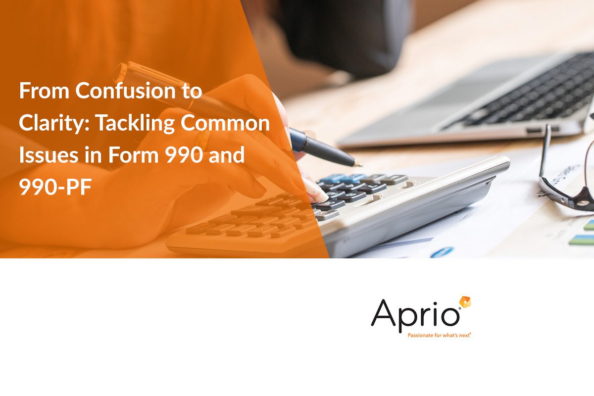 Person using a calculator with text overlay: From Confusion to Clarity: Tackling Common Issues in Form 990 and 990-PF. Aprio logo at the bottom.