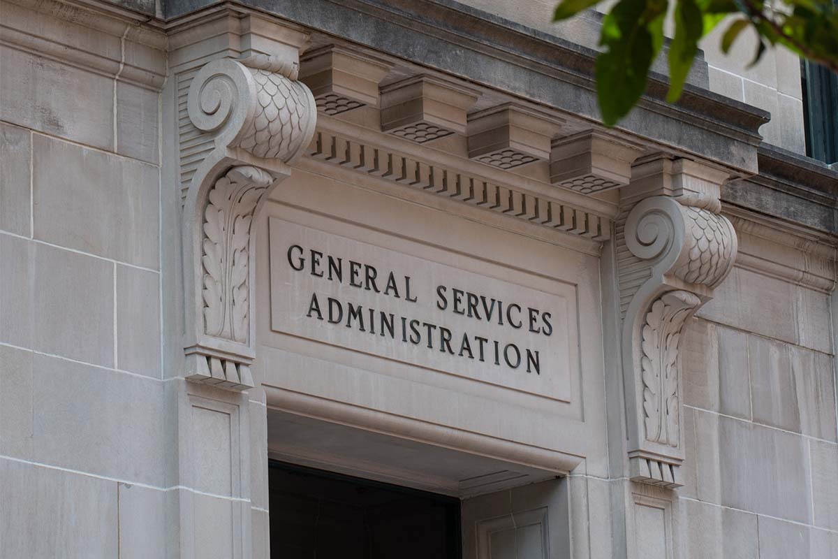Stone building facade with decorative columns showing the carved words General Services Administration above an entrance.