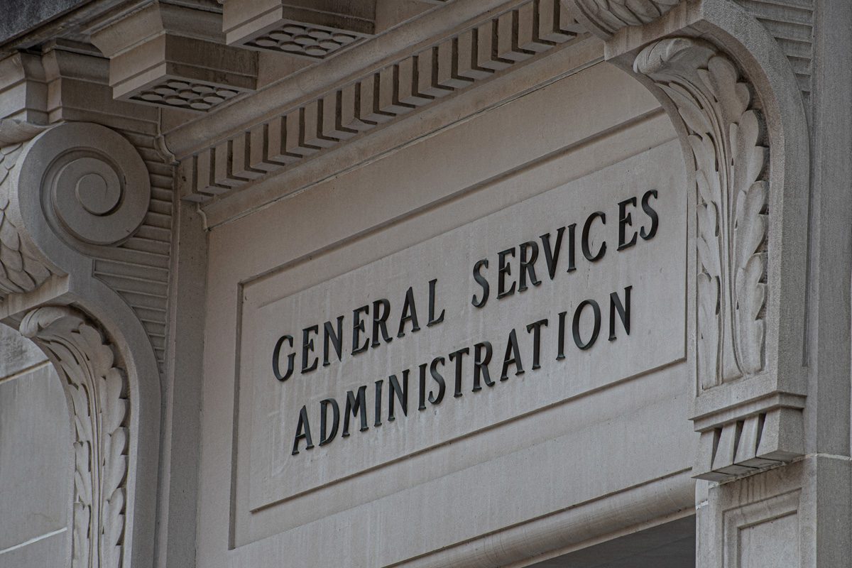 Stone building facade with the words General Services Administration engraved above an entrance, surrounded by decorative architectural elements.