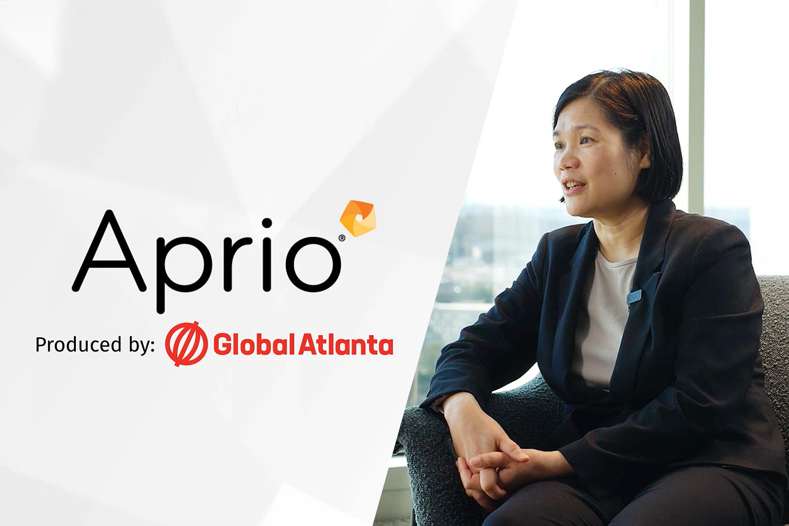 A woman in business attire sits in a chair by a window. The image displays the Aprio logo with “Produced by: Global Atlanta” on a white background.