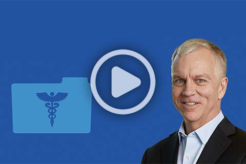 A man in a suit stands in front of a blue background with a medical file icon and a play button symbol.