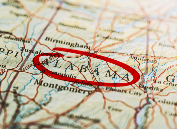 A close-up of a map showing Alabama, with the state name circled in red. Nearby cities like Montgomery and Birmingham are also visible.