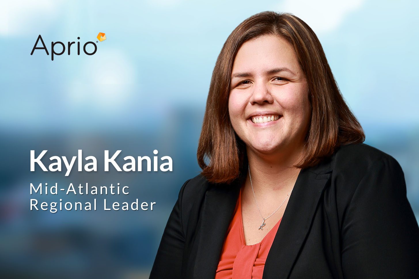 A woman in a blazer smiles at the camera. Text on the image reads: Aprio. Kayla Kania, Mid-Atlantic Regional Leader. Blurred background.