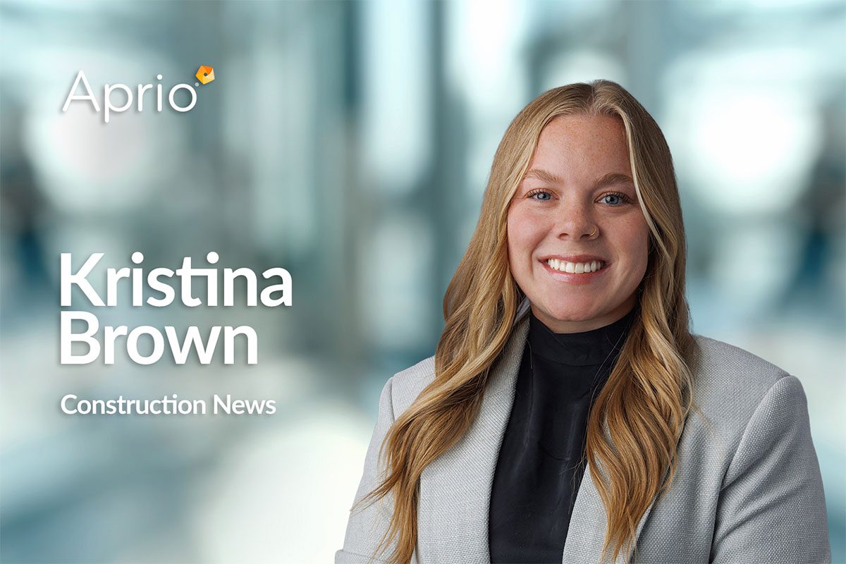 A woman with long blonde hair in a light gray blazer and black top smiles in front of a blurred office background. Text reads: Aprio, Kristina Brown, Construction News.