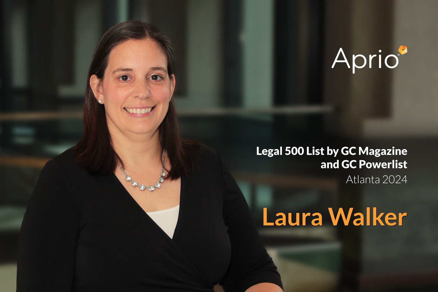 Woman with long brown hair and a black top smiles at the camera. Text reads: Legal 500 List by GC Magazine and GC Powerlist Atlanta 2024. Laura Walker. Aprio.