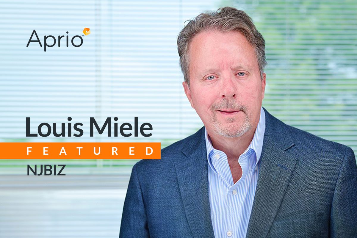 A man in a blue blazer and light shirt stands in front of blinds. Text reads: Aprio. Louis Miele FEATURED NJBIZ.