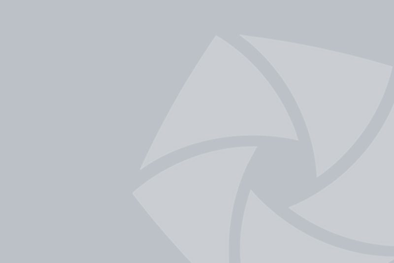 A grey background with a faint, abstract geometric pattern consisting of overlapping curved shapes.