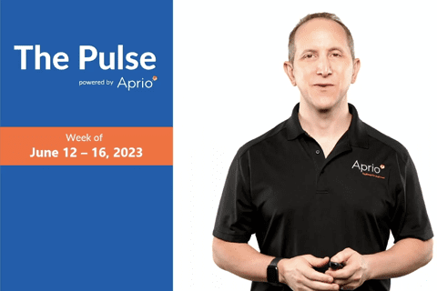 A man in a black Aprio polo shirt stands next to a blue and orange graphic reading The Pulse, Week of June 12 – 16, 2023, powered by Aprio.