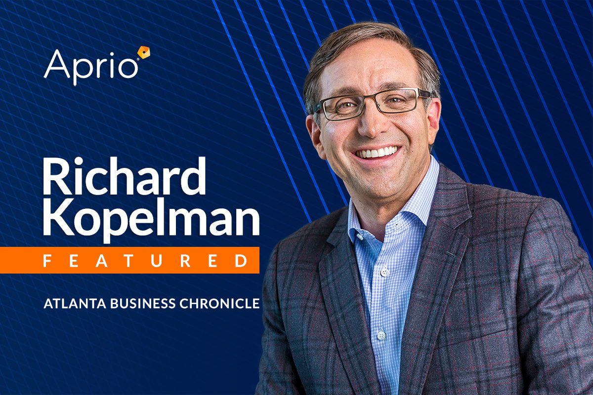 A man in a checked suit jacket smiles beside text reading Aprio, Richard Kopelman, Featured, Atlanta Business Chronicle on a blue geometric background.