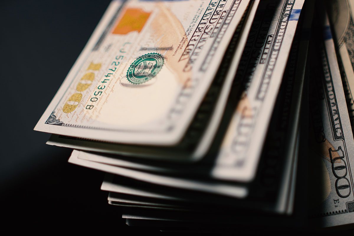 A close-up view of a stack of U.S. one hundred dollar bills.