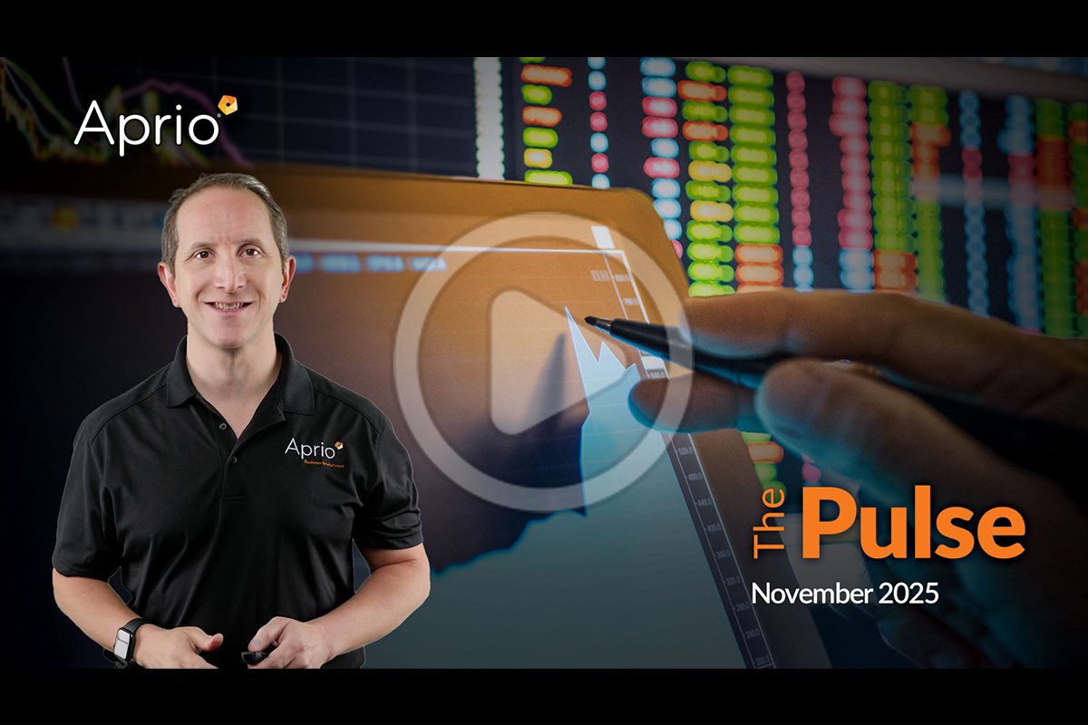 A man in an Aprio shirt stands in front of a large screen displaying financial charts, with the words The Pulse November 2025 and a play button overlay.