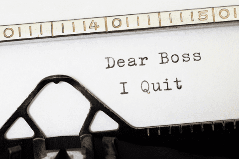 A typed letter in a typewriter reads, Dear Boss I Quit.
