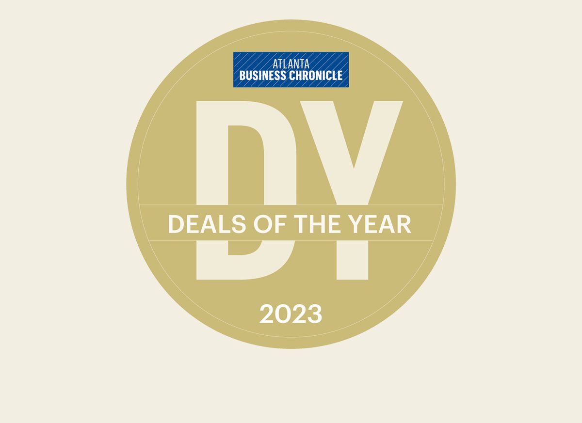 Atlanta Business Chronicle Deals of the Year 2023 gold circular badge with bold white text on a light background.