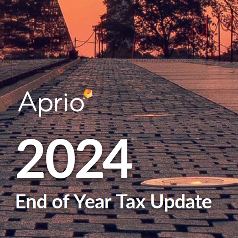 A paved walkway at sunset with trees in the background. Overlaid text reads: “Aprio 2024 End of Year Tax Update.”.