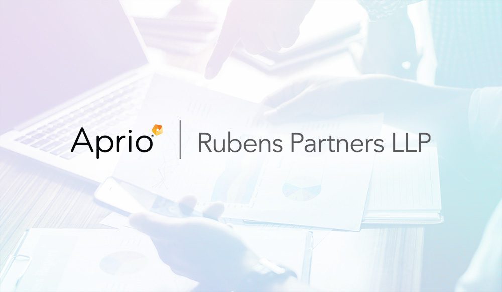 Logo for Aprio and Rubens Partners LLP overlaid on an image of people working with documents, a laptop, and a smartphone.