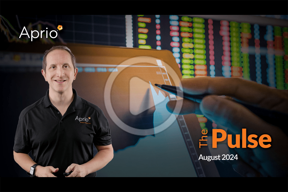 A man in an Aprio shirt stands beside a digital graph and stock market data screen; text reads The Pulse, August 2024.