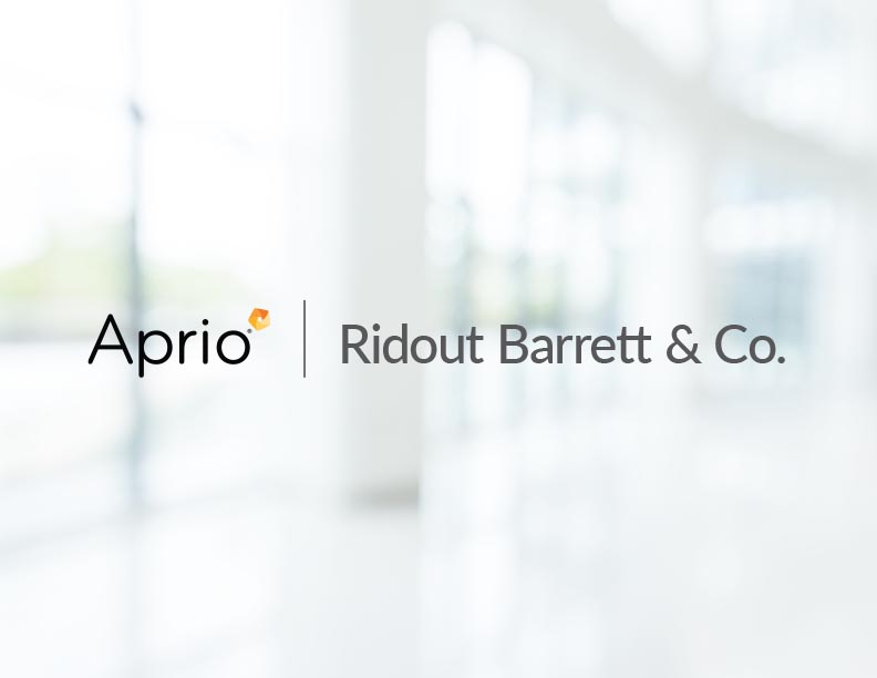 Logo for Aprio and Ridout Barrett & Co. displayed on a blurred, bright background with large windows.