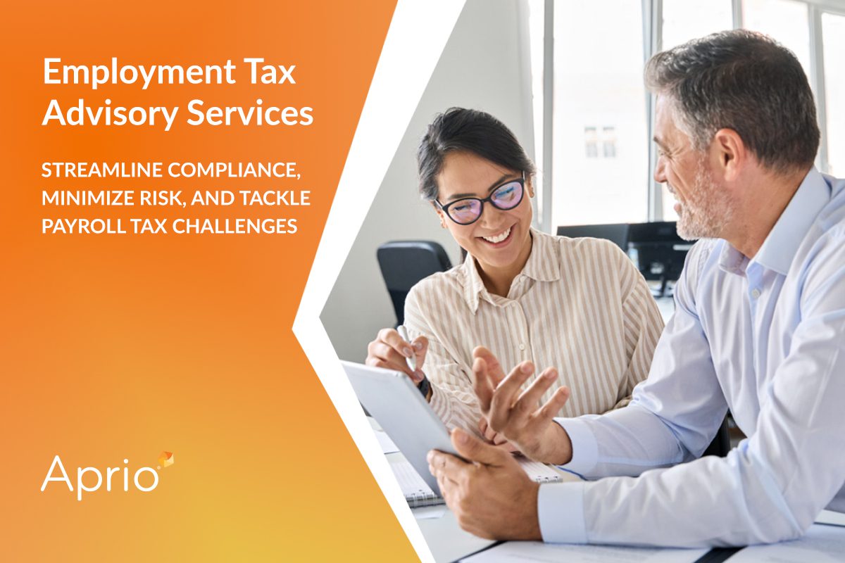 Two professionals discuss documents at a desk; text on the left advertises Employment Tax Advisory Services from Aprio, highlighting compliance, risk minimization, and payroll tax challenges.