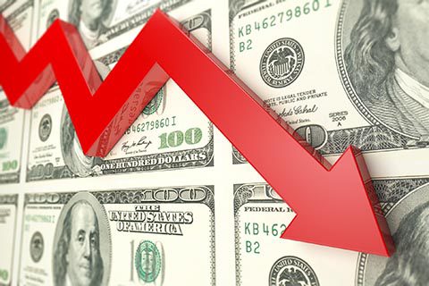 Red downward arrow overlaid on multiple U.S. hundred dollar bills, symbolizing a decline in financial value or economic downturn.