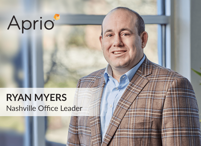 A man in a plaid blazer stands indoors by a window. Text reads, Aprio. Ryan Myers, Nashville Office Leader.