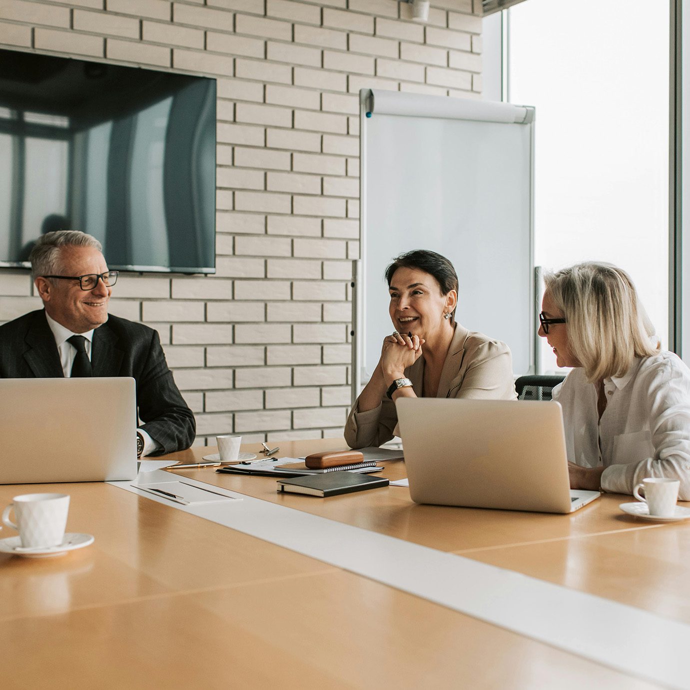 Three business people having a meeting and engaging in lively conversation