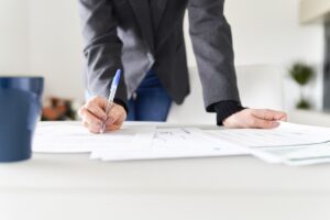 woman working at an accounting firm from home underlining important things about the report she is reading