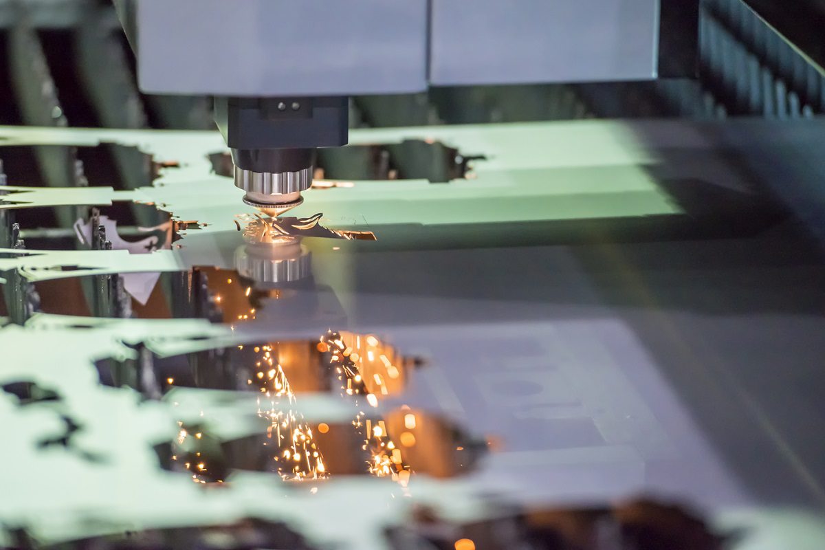 The fiber laser cutting the sheet metal with the sparking light.