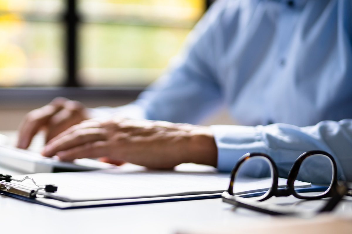 Late Invoice And Billing Deadline With Hourglass At Desk