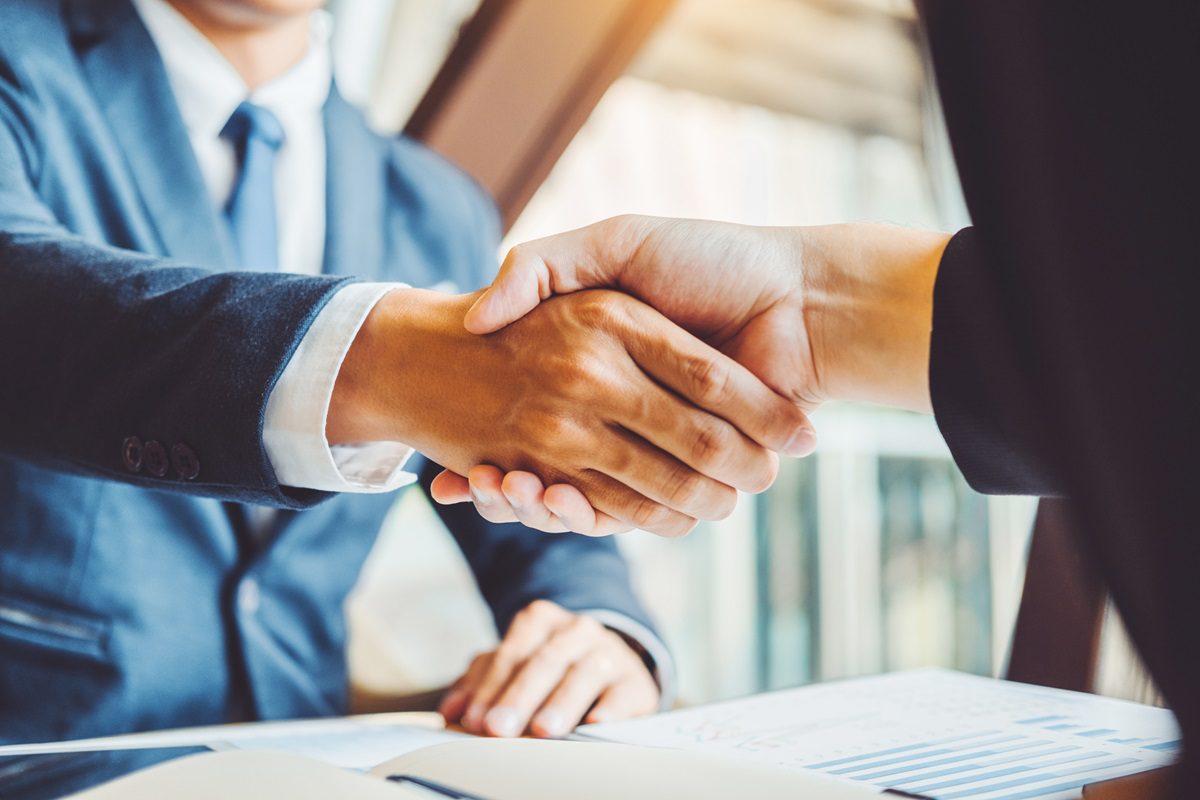 Business people colleagues shaking hands during a meeting to sign agreement for New Partner Planning Strategy Analysis Concept