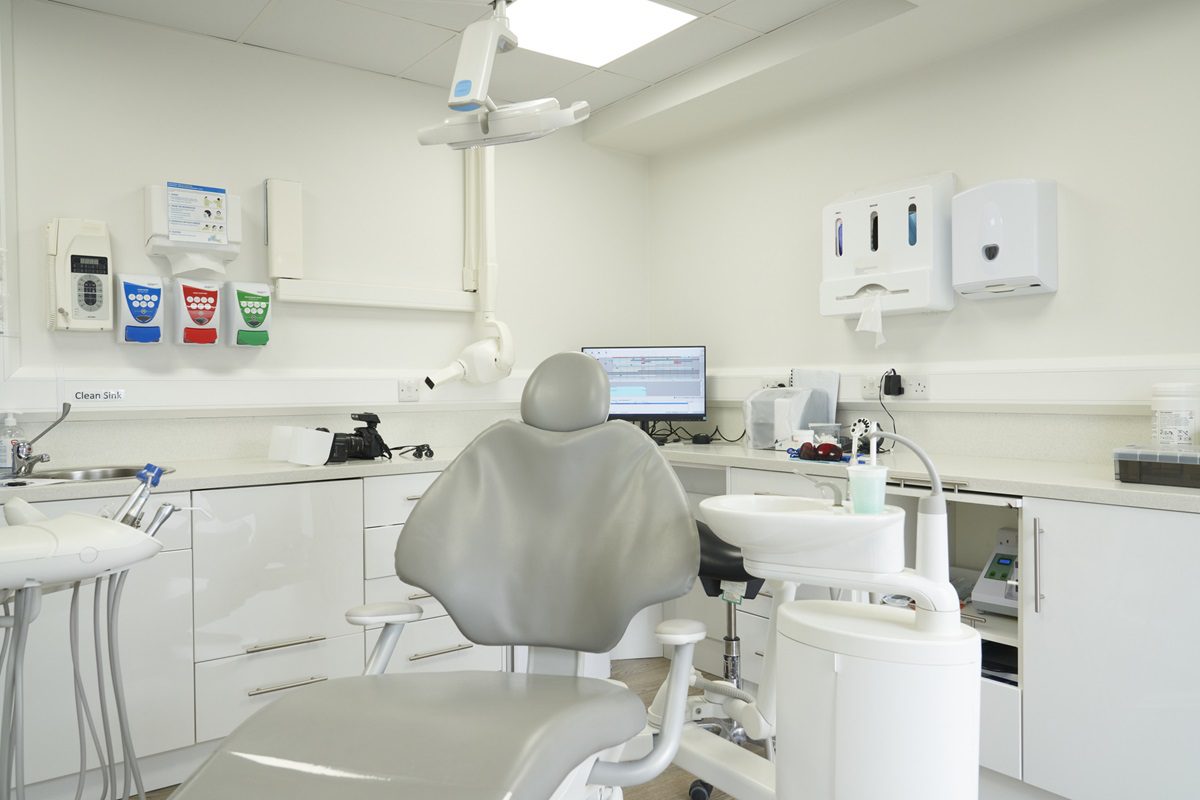a dentists chair in the middle of a modern new dental surgery white / Female Focus Collection