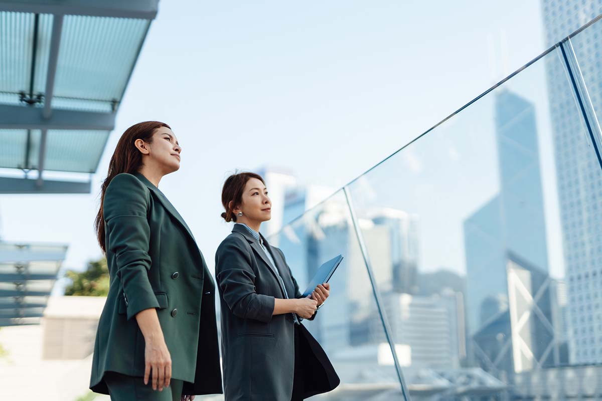 Two businesswomen walking in an international city