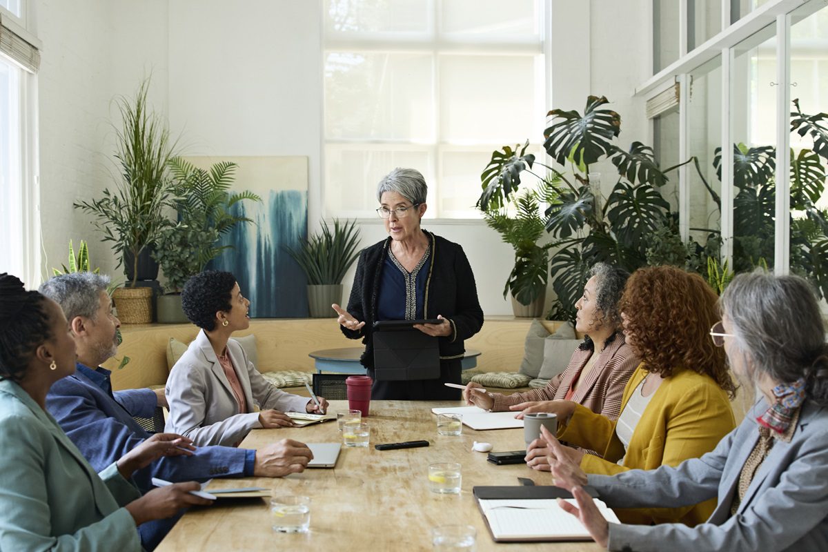 Senior businesswoman conducting training session for office staff